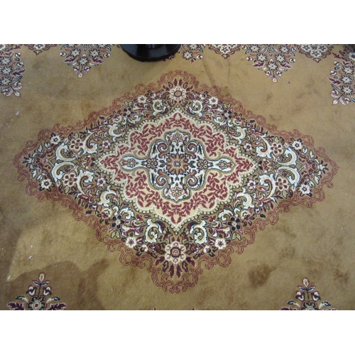 7632 - A mustard ground machine woven rug, central floral medallion, 266cm x 350cm