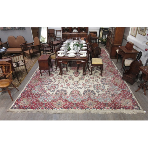 7633 - A large 20th Century cream carpet with central floral medallion and further floral sprays, 322cm x 5... 