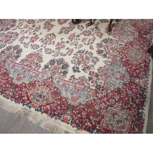 7633 - A large 20th Century cream carpet with central floral medallion and further floral sprays, 322cm x 5... 