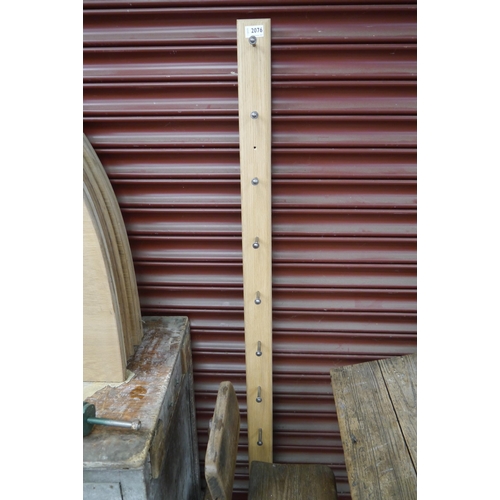 2486 - An oak coat rack 153cm long