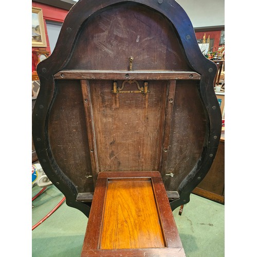 4223 - Circa 1850 a walnut tilt-top table, the serpentine sided top over a melon fluted and turned column o... 