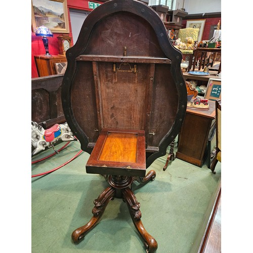 4223 - Circa 1850 a walnut tilt-top table, the serpentine sided top over a melon fluted and turned column o... 