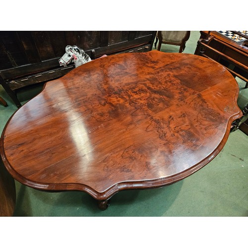 4223 - Circa 1850 a walnut tilt-top table, the serpentine sided top over a melon fluted and turned column o... 