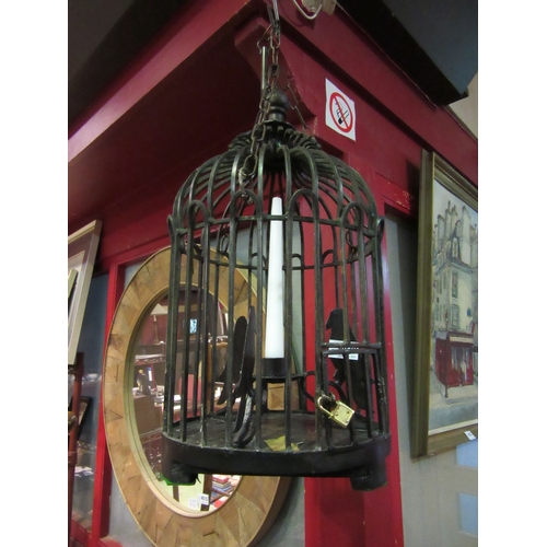 4020 - A wrought iron hanging birdcage candle holder with key, 54cm high