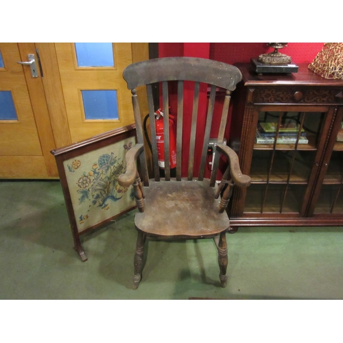 4025 - An oak lathe back grandfather chair on 'H' stretcher base together with a tapestry firescreen