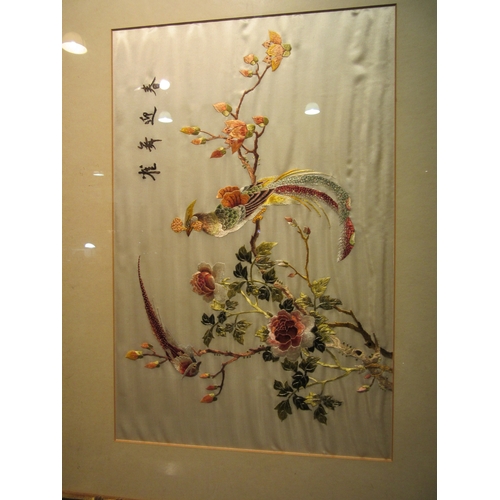 4027 - A framed and glazed pair of Chinese silk embroidered pictures, mid-20th Century. Image sizes 51cm x ... 