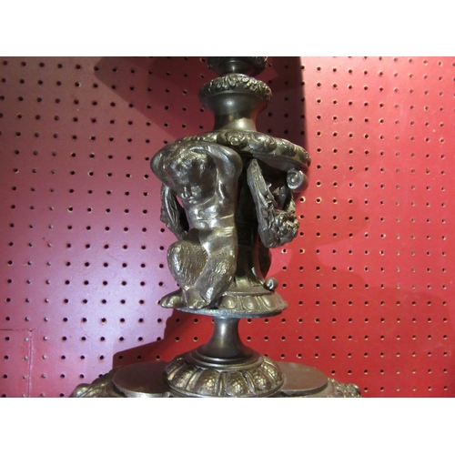 4029 - A brass bronze effect figural table lamp with fern and mask detail on marble base, with pale green s... 