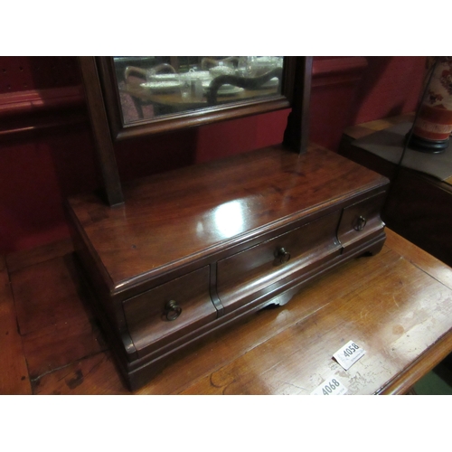 4066 - A 19th Century toilet mirror. The tilting mirror over a three drawer base on bracket feet, total 60c... 