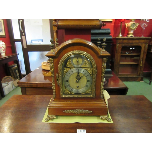 4121 - A Dutch walnut mantel clock, bevelled glass, brass face and feet, finials and decoration, 39cm tall