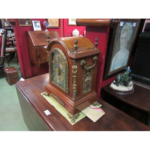 4121 - A Dutch walnut mantel clock, bevelled glass, brass face and feet, finials and decoration, 39cm tall