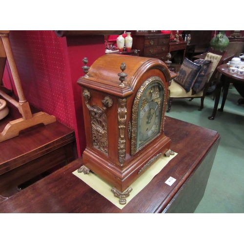 4121 - A Dutch walnut mantel clock, bevelled glass, brass face and feet, finials and decoration, 39cm tall