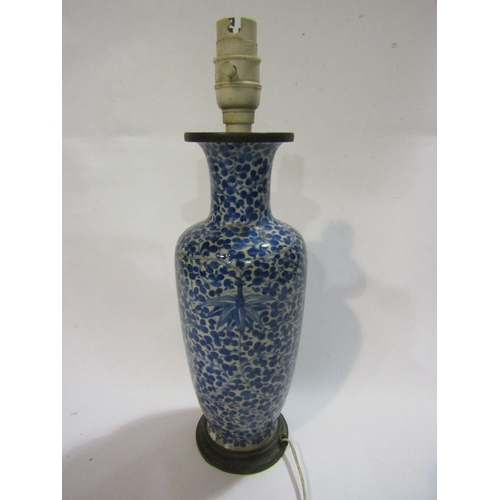 1296 - A Chinese blue and white porcelain vase of baluster form, allover foliage, converted into a lamp bas... 