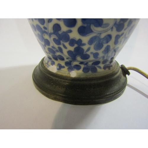 1296 - A Chinese blue and white porcelain vase of baluster form, allover foliage, converted into a lamp bas... 