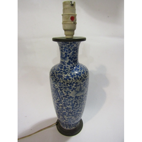 1296 - A Chinese blue and white porcelain vase of baluster form, allover foliage, converted into a lamp bas... 