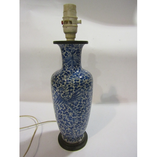 1296 - A Chinese blue and white porcelain vase of baluster form, allover foliage, converted into a lamp bas... 