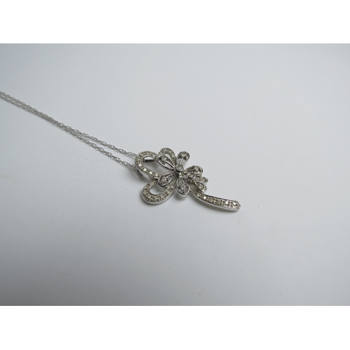 7029 - A diamond encrusted floral pendant 3.5cm tall unmarked on 9ct gold chain