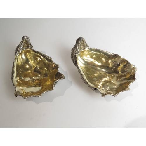 7049 - A pair of silver table salts in the form of clam shells, london 1998, 9cm long, 431g