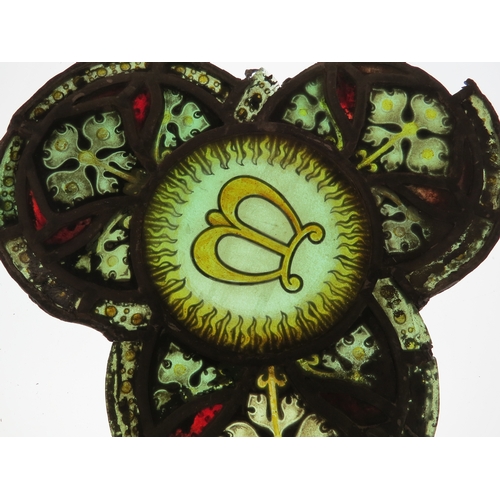 7628 - A leaded glass trefoil panel depicting central miter, damaged, 33cm x 32cm