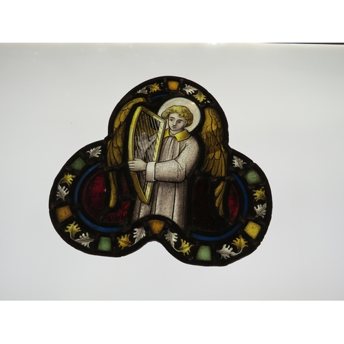 7629 - A leaded glass trefoil panel depicting angel and harp, 33cm x 32cm