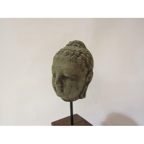 4054 - A replica ancient head of Buddha on plinth base, 24cm tall