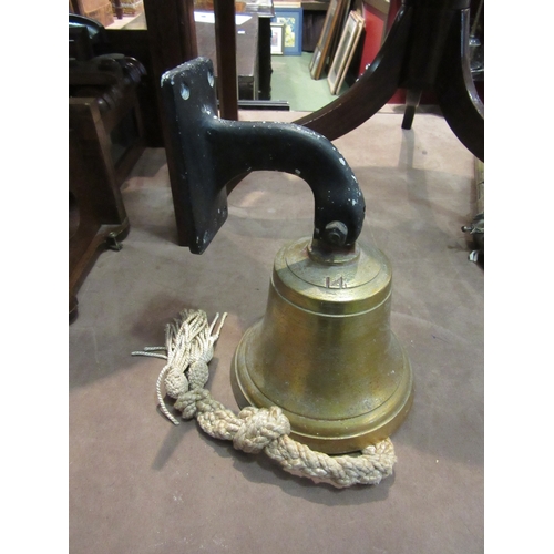 4261 - A brass bell stamped 14 with wall bracket