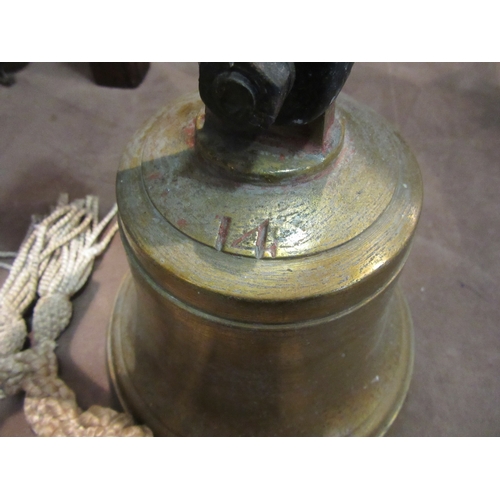 4261 - A brass bell stamped 14 with wall bracket