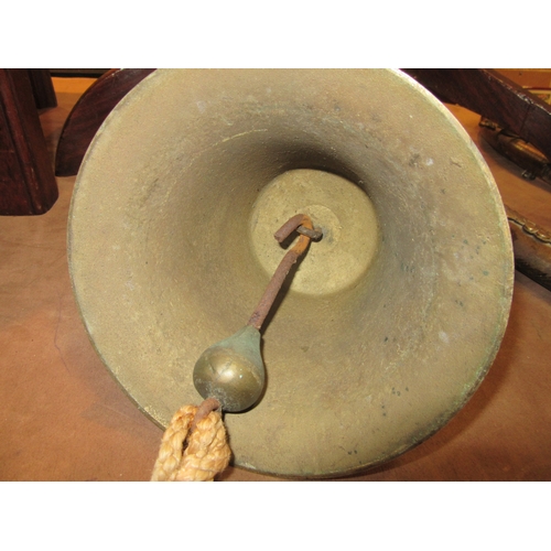 4261 - A brass bell stamped 14 with wall bracket