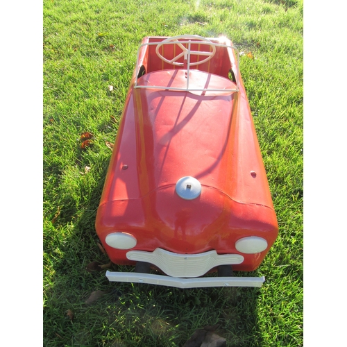 9144 - A mid 20th Century Triang pressed steel pedal car, repainted in red with white grille and hubs, 100c... 