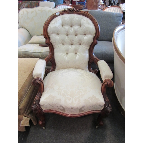 1183 - A Victorian walnut spoon-back armchair, damask buttoned upholstery, carved scrolled frame raised on ... 