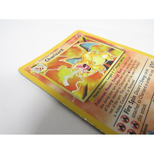 9047 - A 1990s Pokémon TCG Charizard base set holographic shiny card, no. 4/102