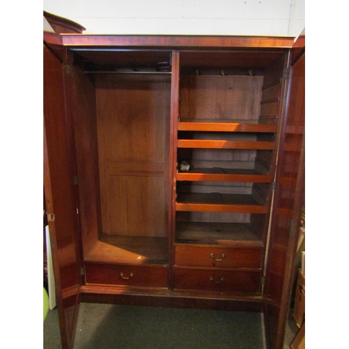 1069 - An Edwardian mahogany two door wardrobe with scrolled acanthus leaf detail, linen trays and three in... 