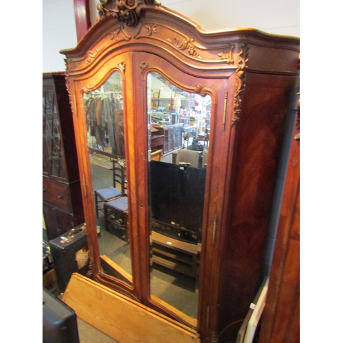 1071 - A late 19th Century French walnut armoire with ornately carved detailing, 250cm tall x 165cm wide x ... 