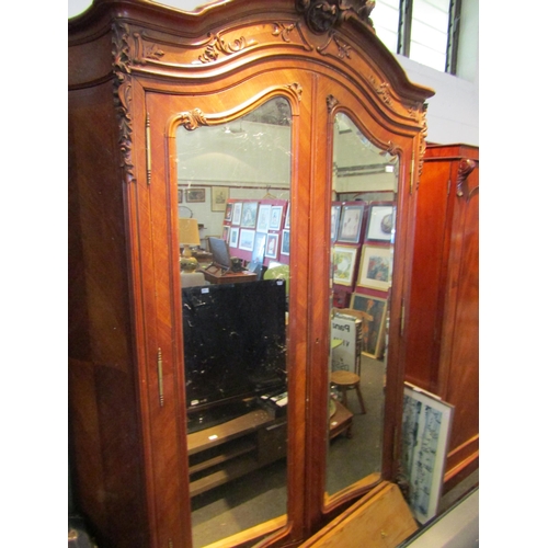 1071 - A late 19th Century French walnut armoire with ornately carved detailing, 250cm tall x 165cm wide x ... 