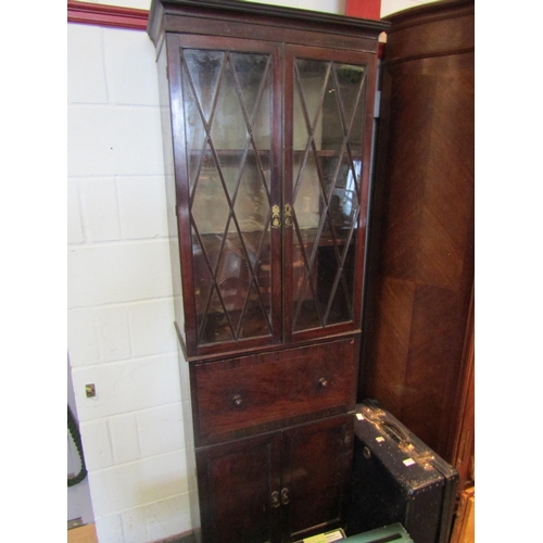 1073 - A 19th Century mahogany full height cabinet of slim proportions, the astragal glazed two door top ov... 