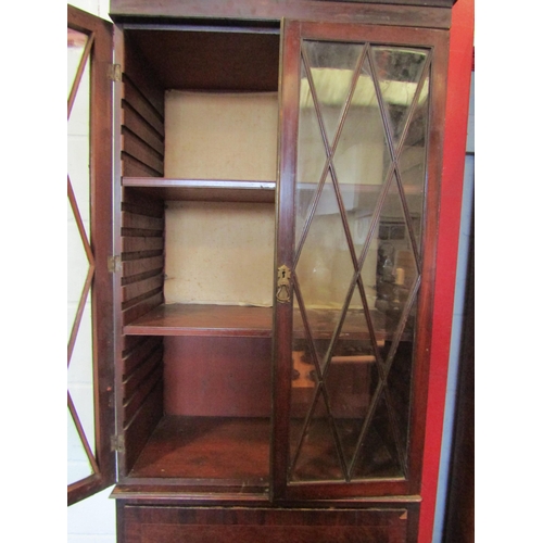 1073 - A 19th Century mahogany full height cabinet of slim proportions, the astragal glazed two door top ov... 