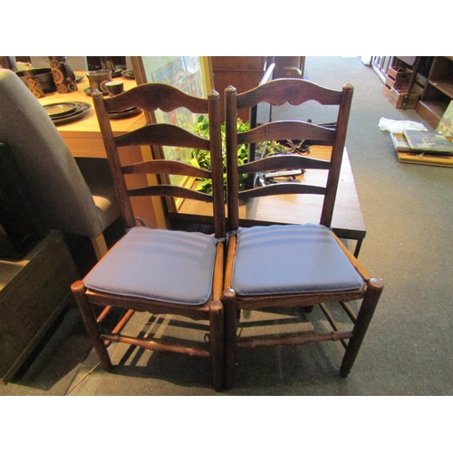 1078 - A pair of early 19th Century country ladder-back chairs, solid seats