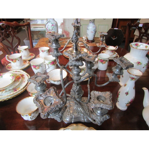 1136 - A matched set of three silver plate on copper and plated candelabra consisting of a centrepiece and ... 