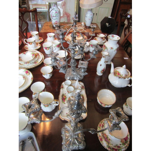 1136 - A matched set of three silver plate on copper and plated candelabra consisting of a centrepiece and ... 