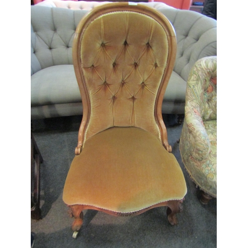 1186 - A Victorian walnut button-back open armchair, dark tan velour upholstery, scroll feet to porcelain c... 