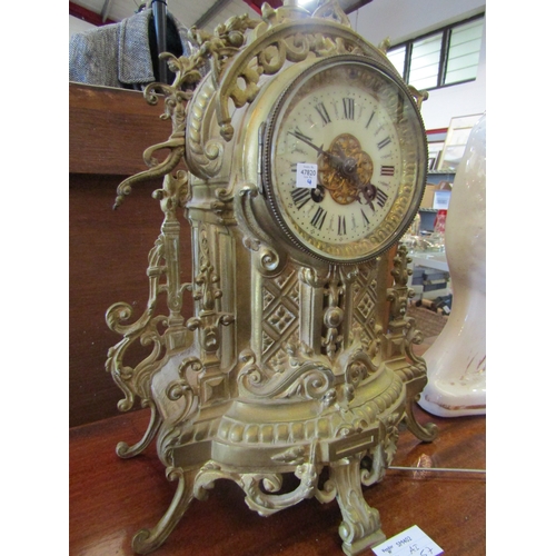 1147 - A late 19th/early 20th Century gilt brass mantel clock, Roman ceramic dial, urn finial