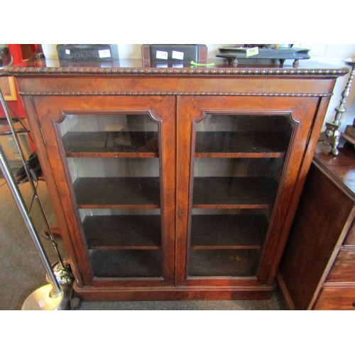 1012 - A near pair of mid-19th Century walnut glazed bookshelves, beadwork moulding on plinth bases, 114cm ... 