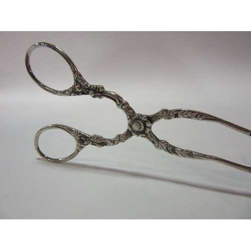 1387 - A pair of continental silver serving tongs, pierced scrolled foliate detail, 49g