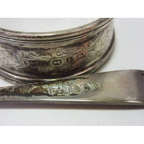 1404 - An Indian white metal leaf form cruet with associated spoon, silver napkin ring and four napkin ring... 