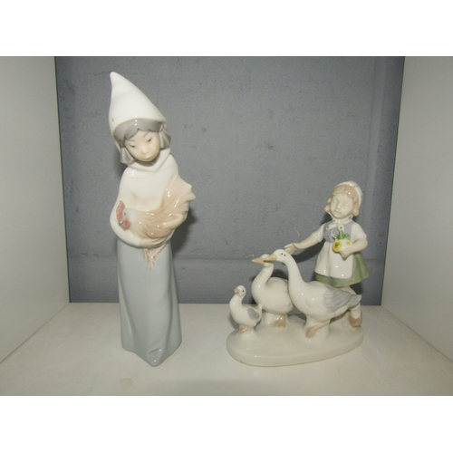 1322 - A Lladro figurine of young girl holding chicken and a similar figure of young girl and three geese