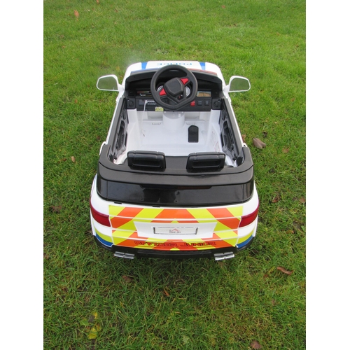 9143 - A Homecom 12v battery driven police car with accessories, 100cm long