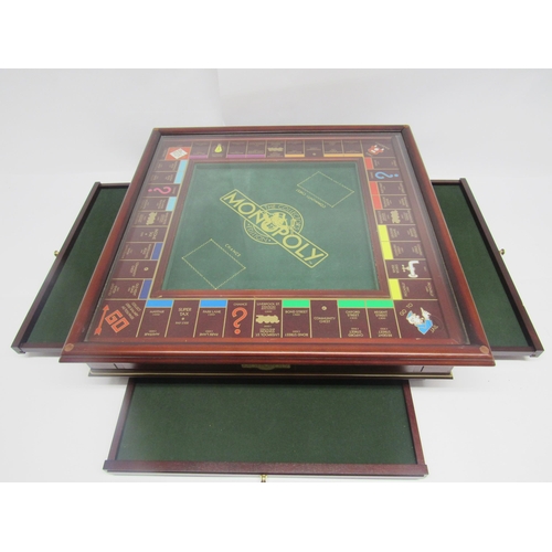 9054 - A Franklin Mint Monopoly The Collectors Edition board game, the mahogany board with green baize cent... 