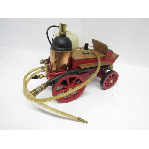 9152 - A scratch built wooden model Nuneaton fire service fire engine, 64cm long, with live steam trailer c... 