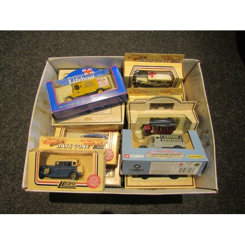 1556 - A box of Lledo 'Days Gone' collectors model cars with biscuit tin