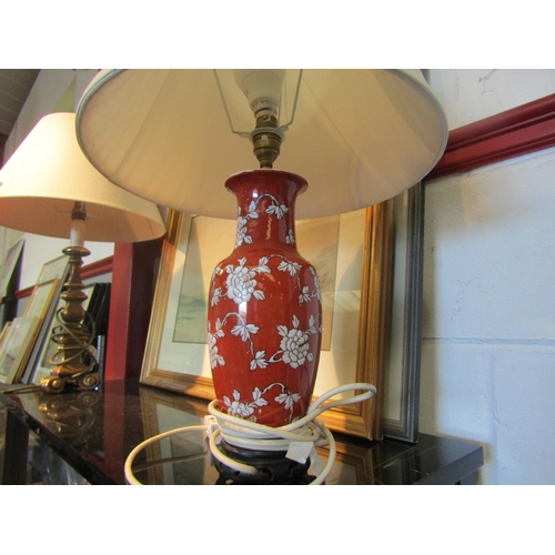 1575 - An Oriental table lamp, red ground with white floral sprays