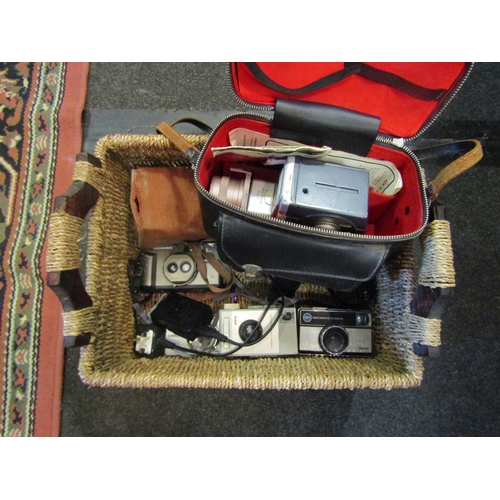 1634 - A basket containing assorted cameras including Hanimex, Samsung and Crown